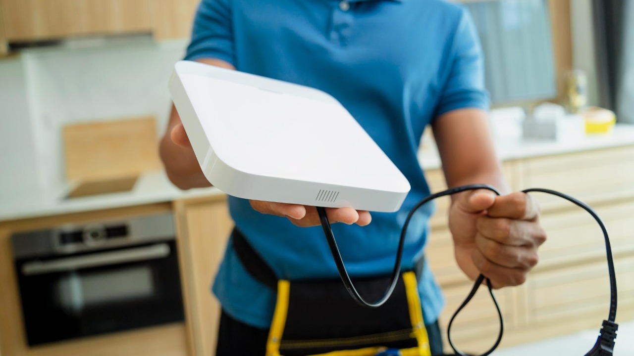 A technician installing internet at home