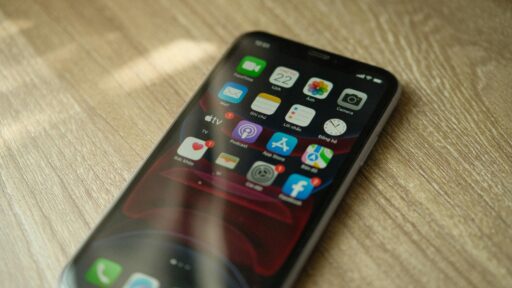 A close-up view of smart phone (Iphone) showing many apps ios 18