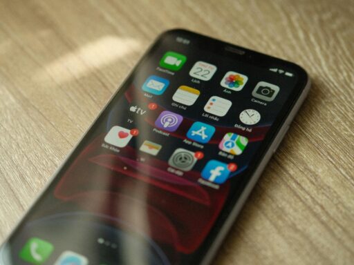 A close-up view of smart phone (Iphone) showing many apps ios 18