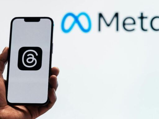 A hand holding phone opening Threads