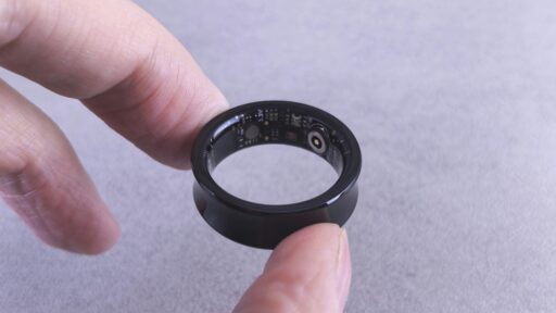 Finger hold a black smart ring