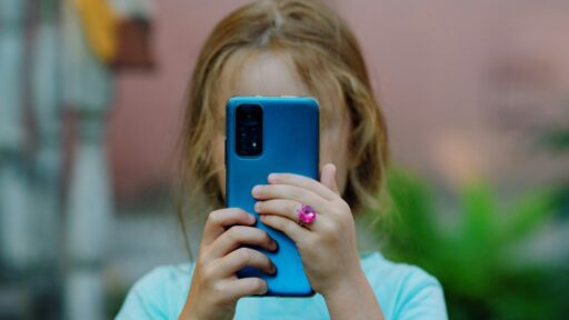 a little girl using phone