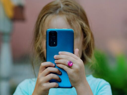 a little girl using phone