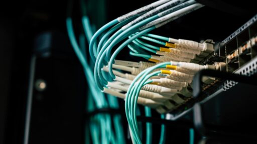 network cables plugged into a rack in data center