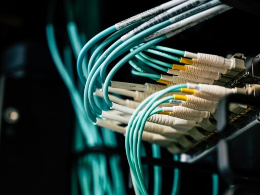 network cables plugged into a rack in data center