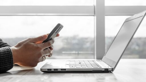 A Business Man working in an office using laptop and mobile