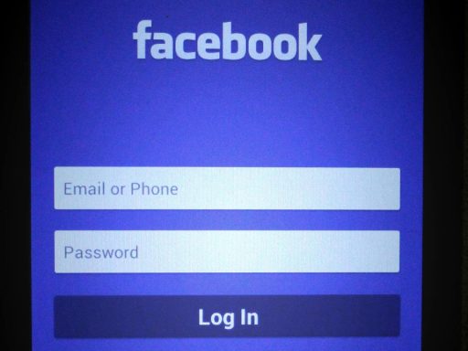 a black smartphone showing login page on mobile