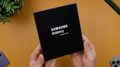 a person holding black box with samsung logo