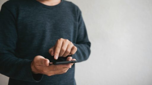 man using cellphone for searching data