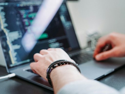 Person using laptop for coding Xcode