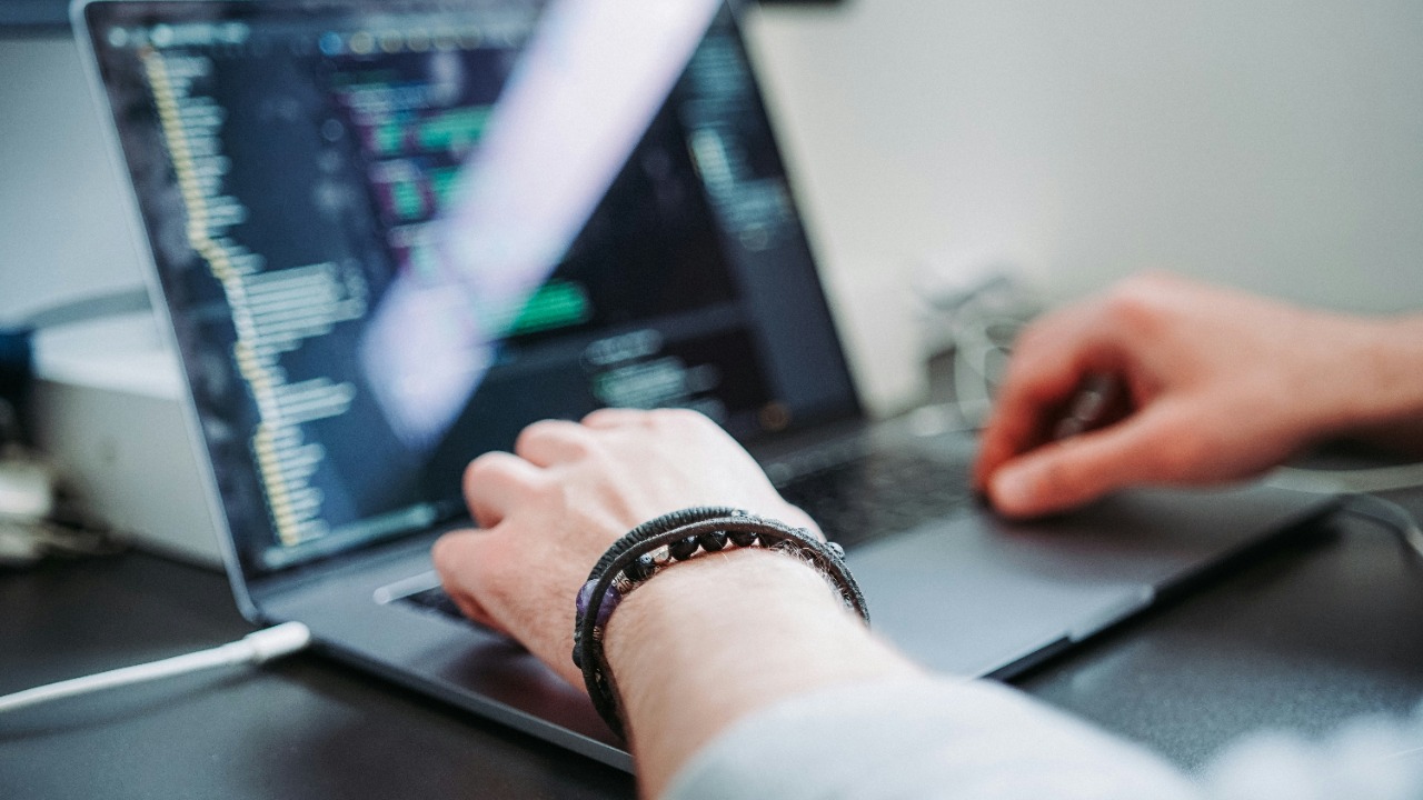 Person using laptop for coding Xcode
